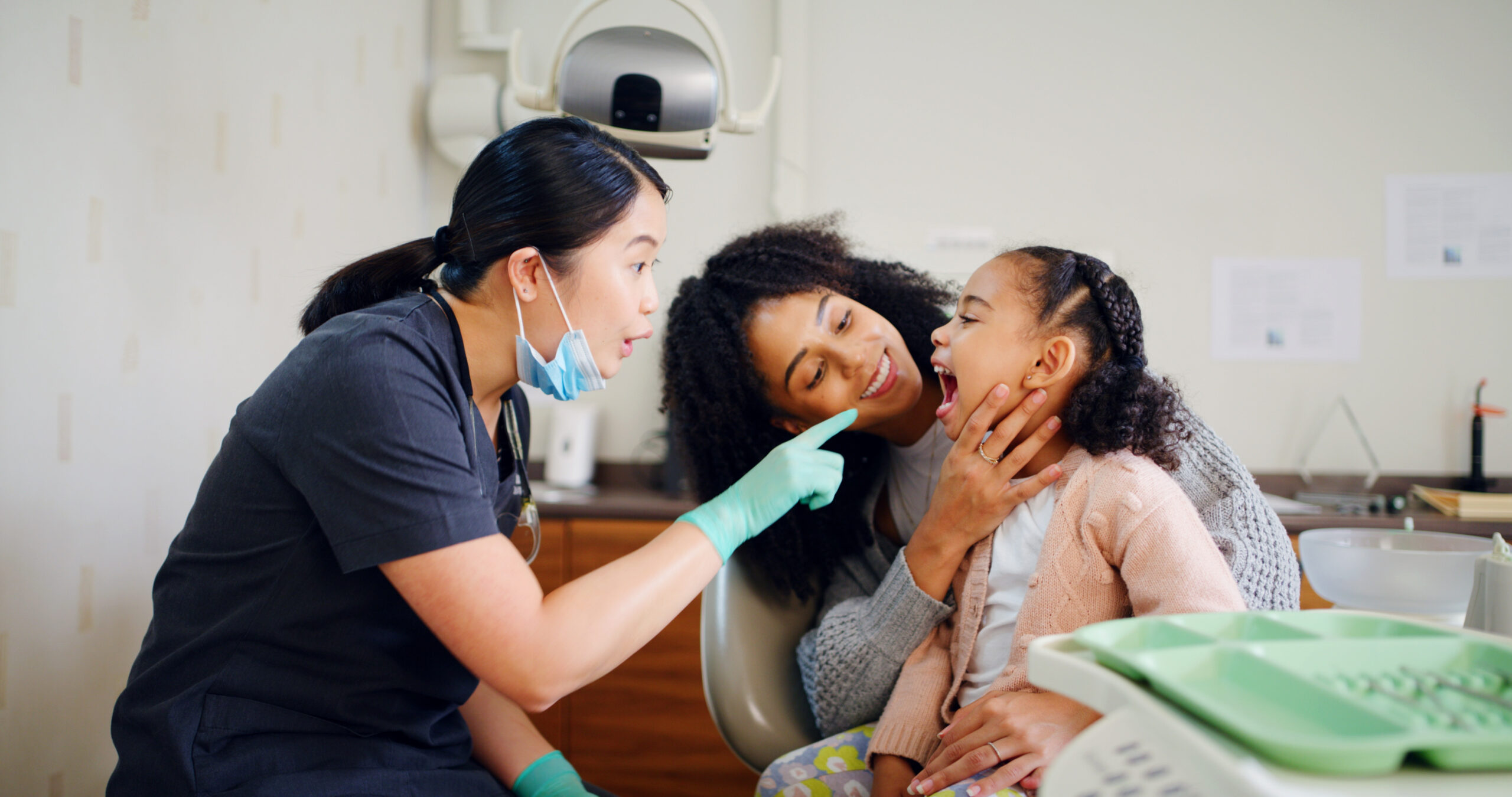 girl getting dental checkup exam at pediatric dentist